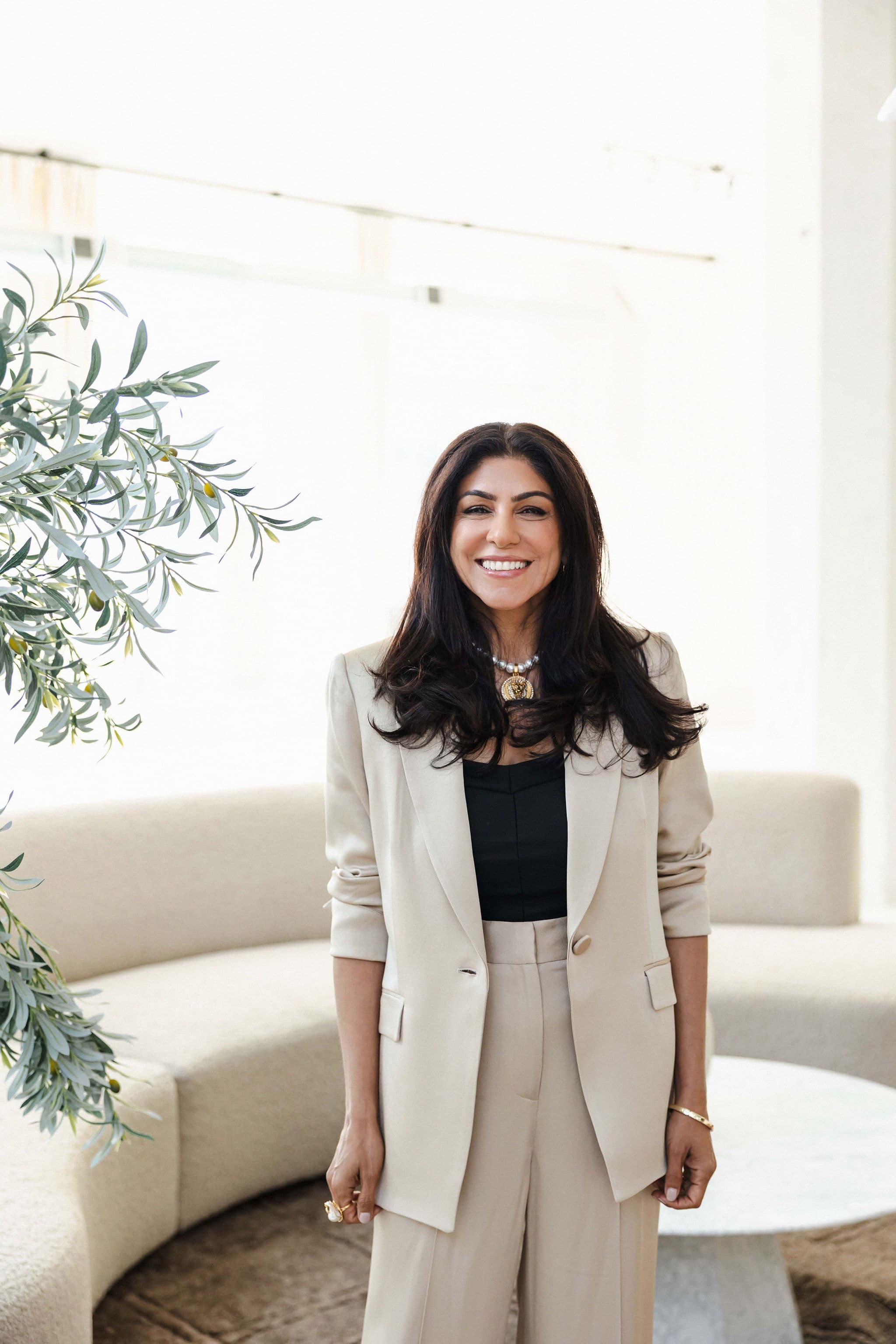 Gauri Chawla standing and smiling in a bright room